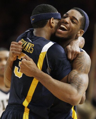 West Virginia’s Devin Ebanks, left, celebrates with John Flowers after beating Pittsburgh 74-60 in the quarterfinals of the Big East tourney.  (Associated Press / The Spokesman-Review)
