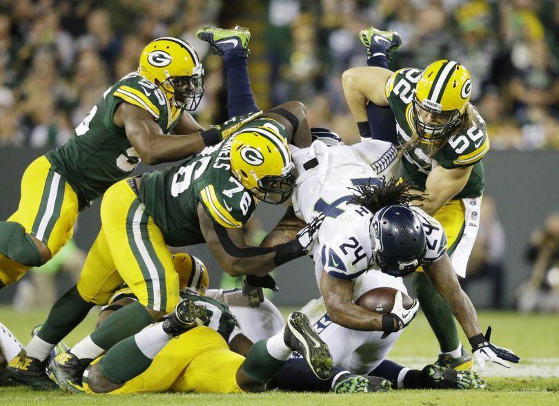 Seattle Seahawks' Marshawn Lynch is stopped by Green Bay Packers' Clay Matthews (52), Mike Daniels (76) and Andy Mulumba (55) during the first half of an NFL football game Sunday in Green Bay, Wis. (AP Photo/Jeffrey Phelps)
