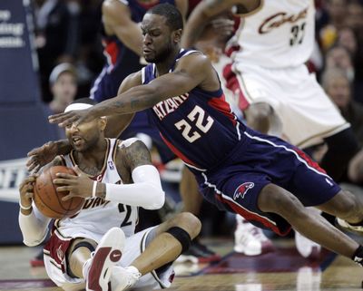 Atlanta Hawks’ Ronald Murray, right, dives onto Cleveland Cavaliers’ Mo Williams during a scramble in the second quarter.  (Associated Press / The Spokesman-Review)