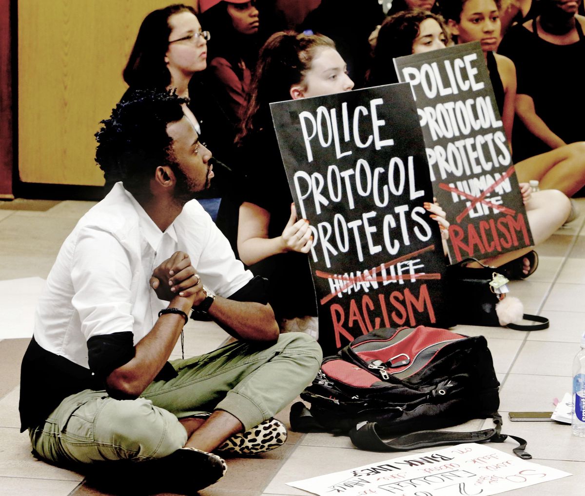 Protesters fill the food court chanting “Black Lives Matter” in the Oklahoma Memorial Union at the University of Oklahoma on Thursday, Sept. 22, 2016 in Norman, Okla. Prosecutors in Tulsa, Oklahoma, charged a white police officer who fatally shot an unarmed black man on a city street with first-degree manslaughter Thursday. (Steve Sisney / Oklahoman via AP)