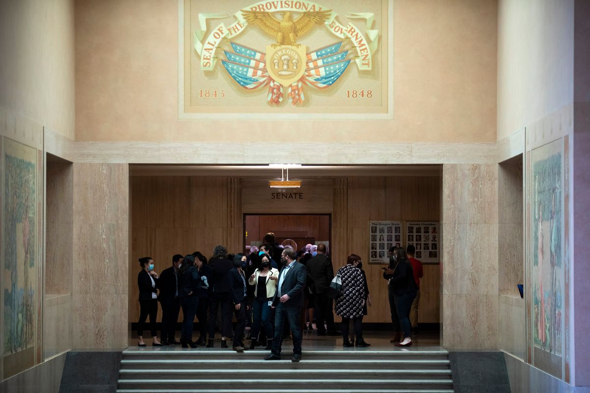 Lawmakers and aides mingle after sine die, the final adjournment of the assembly without a day being set for reconvening, at the Oregon State Capitol Building in Salem, Ore. on Friday, March 4, 2022. (Brian Hayes)