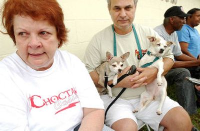 
Hurricane refugees Patricia and August DiFranco and their dogs, Eveie and Eppi, all of Chalmette, La., await medical attention at the at Camp Gruber, Okla.
 (associated press / The Spokesman-Review)