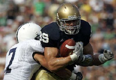 
Notre Dame tight end John Carlson, right, is tackled by Penn State safety Anthony Scirrotto. 
 (Associated Press / The Spokesman-Review)
