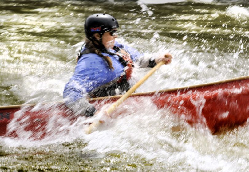 Canoe racer Megan Burgmuller takes spray from the Blackfoot River earlier this week during a practice run through the gates set for the 2014 Open Canoe Slalom National Championship race at Roundup Rapids. (Kurt Wilson / Missoulian)