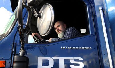 Scott Rogers learns how to back up a tractor-trailer at the Driver Training and Solutions school in Spokane Valley on Wednesday. Rogers was laid off from a commercial glass company and is using his savings to learn to be a trucker.  (Colin Mulvany / The Spokesman-Review)