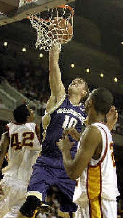 
Washington's Spencer Hawes sends one home against the defense of Southern California's Rousean Cromwell, left, and Taj Gibson, right, during the first half of Thursday's game at Los Angeles. 
 (Associated Press / The Spokesman-Review)