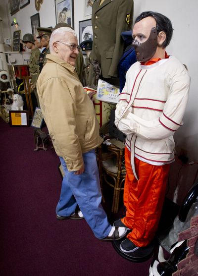 In this 2011 photo, Marvin Carr pushes a button on a Hannibal Lecter statue to make it spout lines from the movie “Silence of the Lambs.” Carr died in November. Everything in his shop will be sold at auction on Saturday. (File)