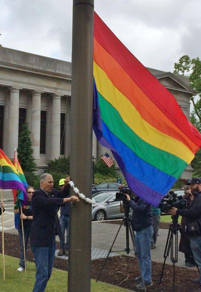 OLYMPIA – Gov. Jay Inslee helped raise the Rainbow flag over the Capitol Campus Friday and said the state succeeds, in part, because it is accepting. companies large and small are willing to come to Washington because it doesn’t care about race, religion or “who a person loves.” (Jim Camden / The Spokesman-Review)