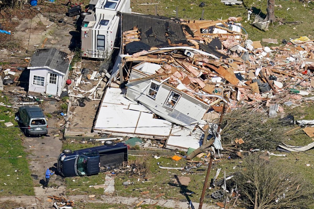 People walk amidst destruction Wednesday from a tornado that struck Tuesday night in Arabi, La.  (Gerald Herbert)