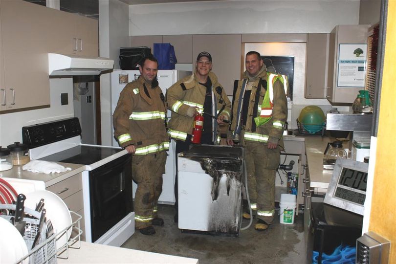 Spokane Valley Fire Department firefighter Joe Rees, paramedic/engineer Dave Fegele and Capt. Chris Neumann put out a kitchen fire caused by a faulty dishwasher inside Station 6 on Monday. The photo is courtesy of the Spokane Valley Fire Department. (Photo courtesy Spokane Valley Fire Department)