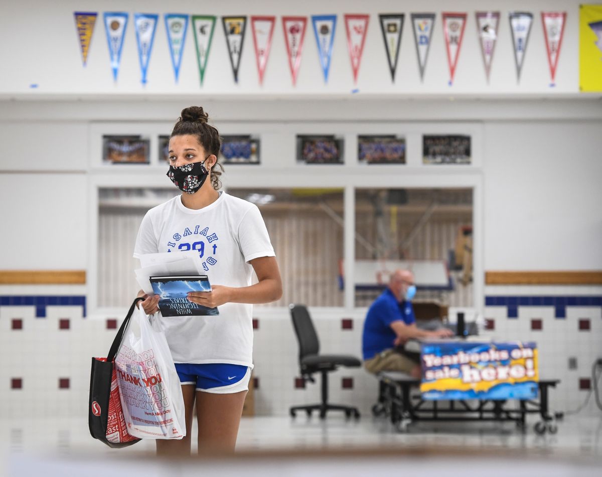 Chase Middle School eighth-grade student Kennedy Smith cleared out her locker and picked up her yearbook, Thursday, June 11, 2020, in Spokane.  (DAN PELLE/The Spokesman-Review)