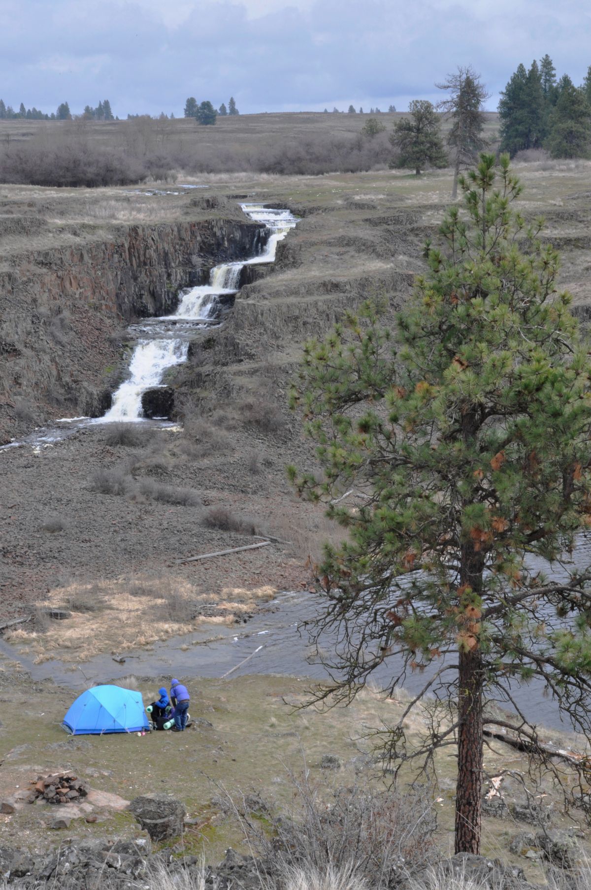 A family of backpackers camp on the BLM land overlooking the waterfall at Hog Canyon Lake. (Rich Landers)
