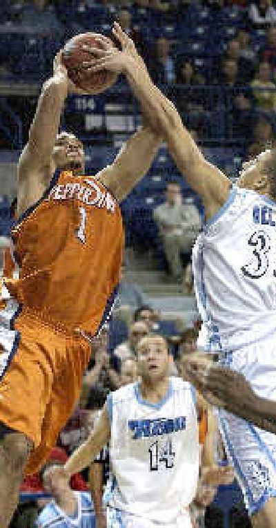 
Pepperdine's Tashaan Forehan-Kelly gets a shot blocked by USD's Corey Belser. 
 (Associated Press / The Spokesman-Review)