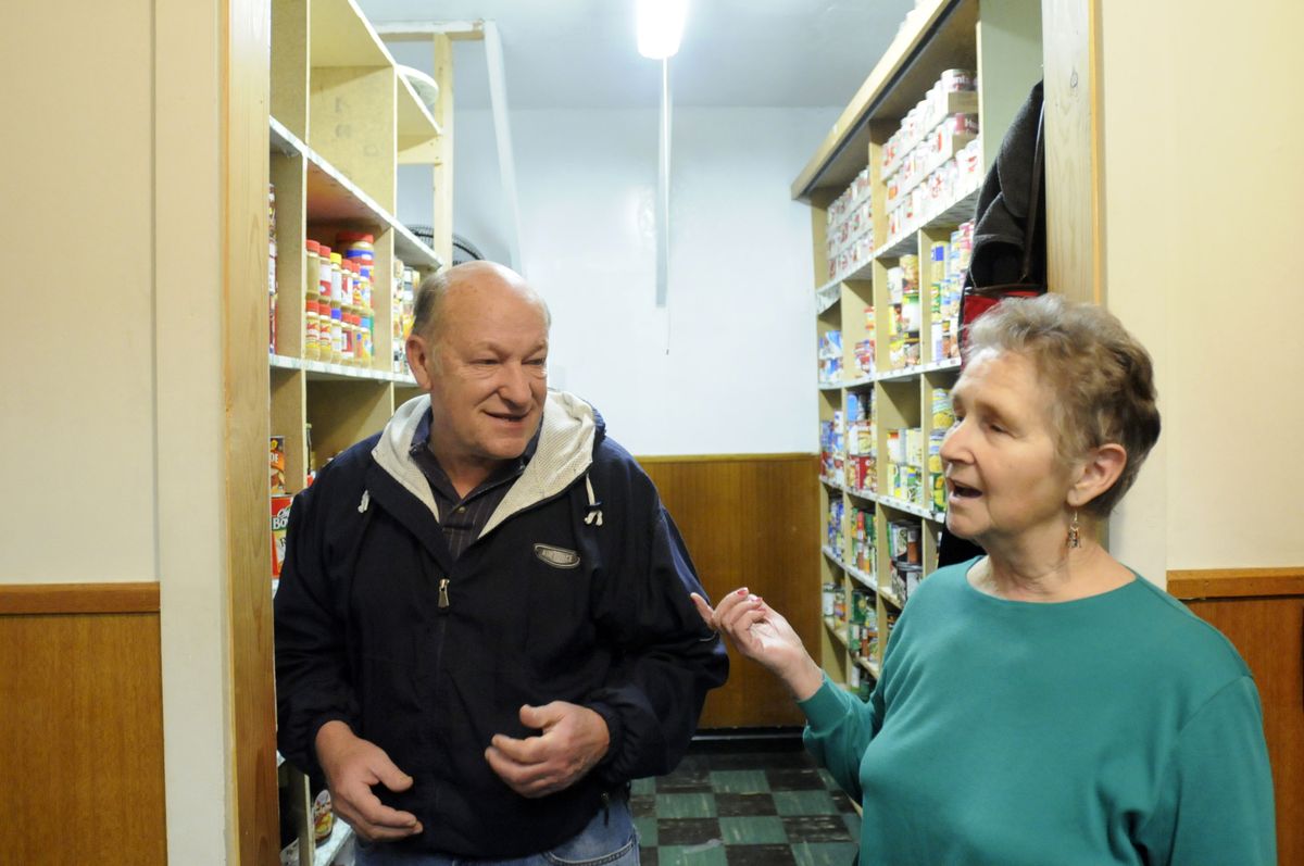 Duane Wolfe and Fran Smith talk about the current stocks at the Medical Lake food bank last week. They are doing well as they approach the holiday season, with some needs for items like pie crusts.  (Jesse Tinsley / The Spokesman-Review)
