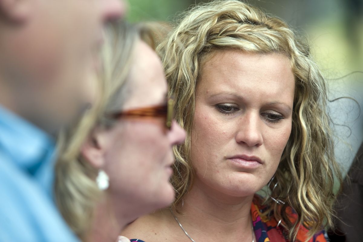 Katie Pehl, sister of Tanner Pehl, looks down while her mother, Laurie Pehl, talks outside the Spokane County Courthouse on Tuesday after Justin W. Crenshaw was found guilty of murdering Tanner Pehl and Sarah Clark. (Jesse Tinsley)