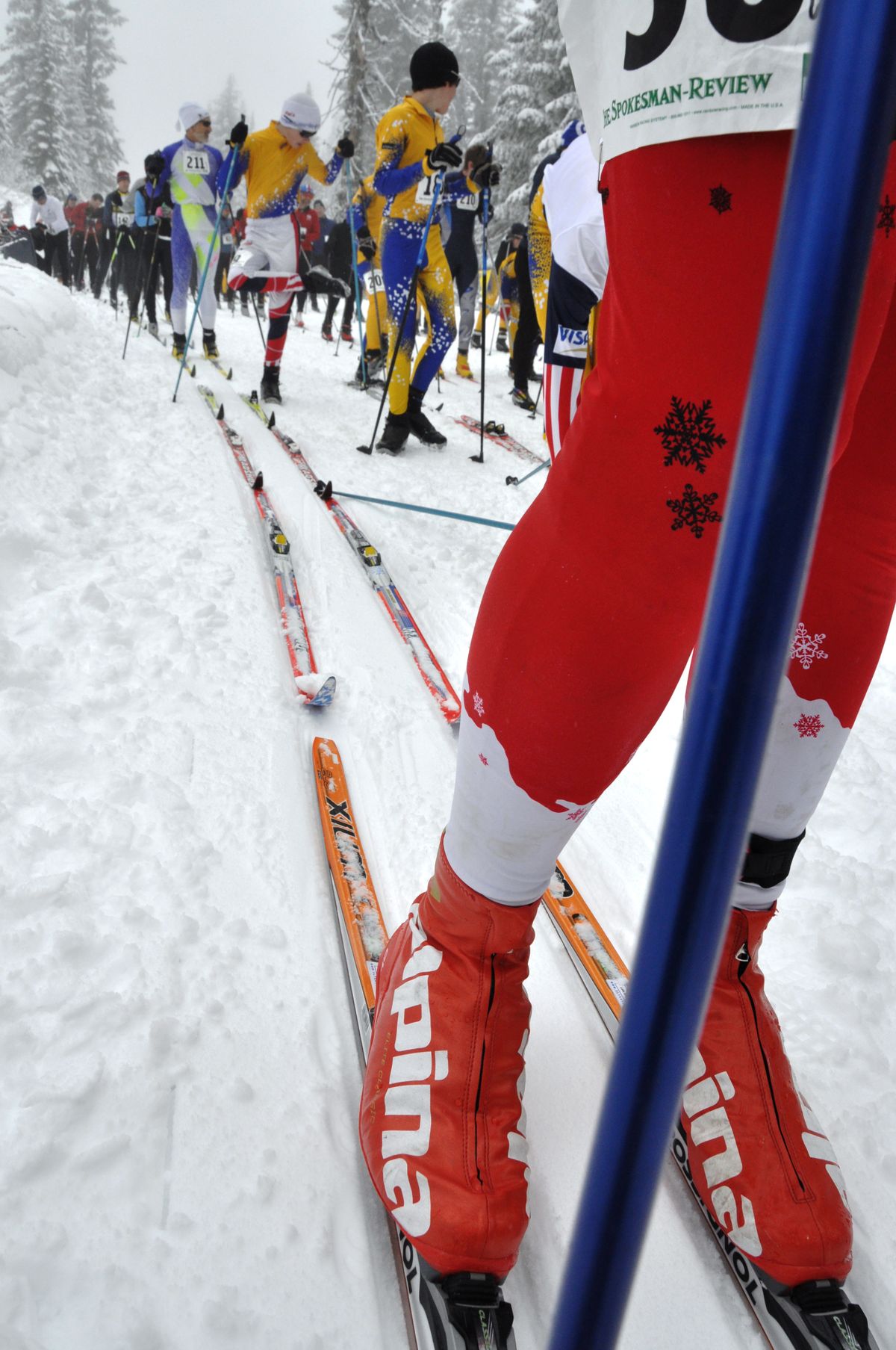 Elite skiers save their sponts before the mass start for 250 competitors in the 34th annual Langlauf 10-kilometer cross-country ski race Sunday at Mount Spokane. The fastest skiers through the foggy conditions were Brad Bauer, 38, of Seattle, the overall winner in 27:33, and Deb Bauer, 46, of Spokane, the top female in 33:01. (Rich Landers)