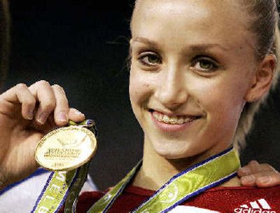 
Anastasia Liukin of the United States holds up her gold medal after her win in the final of the uneven bars at the world gymnastics championships.
 (Associated Press / The Spokesman-Review)