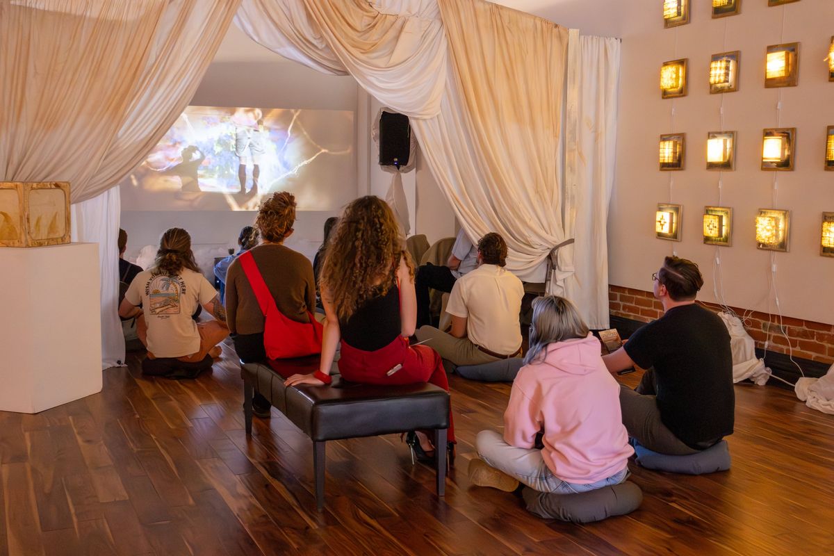 Terrain Gallery patrons enjoy the art documentary “A Sheet From Naked,” directed by Jake Wade, featuring artist Dancan Clark Menzies.  (Courtesy of Andrea Olmstead)