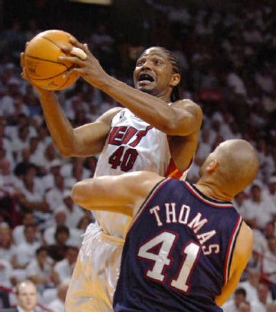 
Miami Heat forward Udonis Haslem goes up for a shot against New Jersey Nets center John Thomas. 
 (Associated Press / The Spokesman-Review)