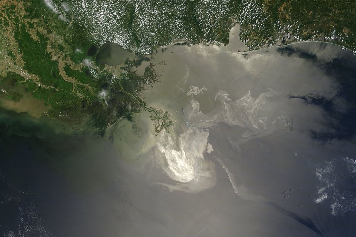 In this May 24, 2010 file satellite image provided by NASA, sunlight reflects off the lingering oil slick from the Deepwater Horizon oil rig explosion off the Mississippi Delta. A high-stakes trial to assign blame and help figure out exactly how much more BP and other companies should pay for the spill began Monday, Feb. 25, 2013. (Associated Press)