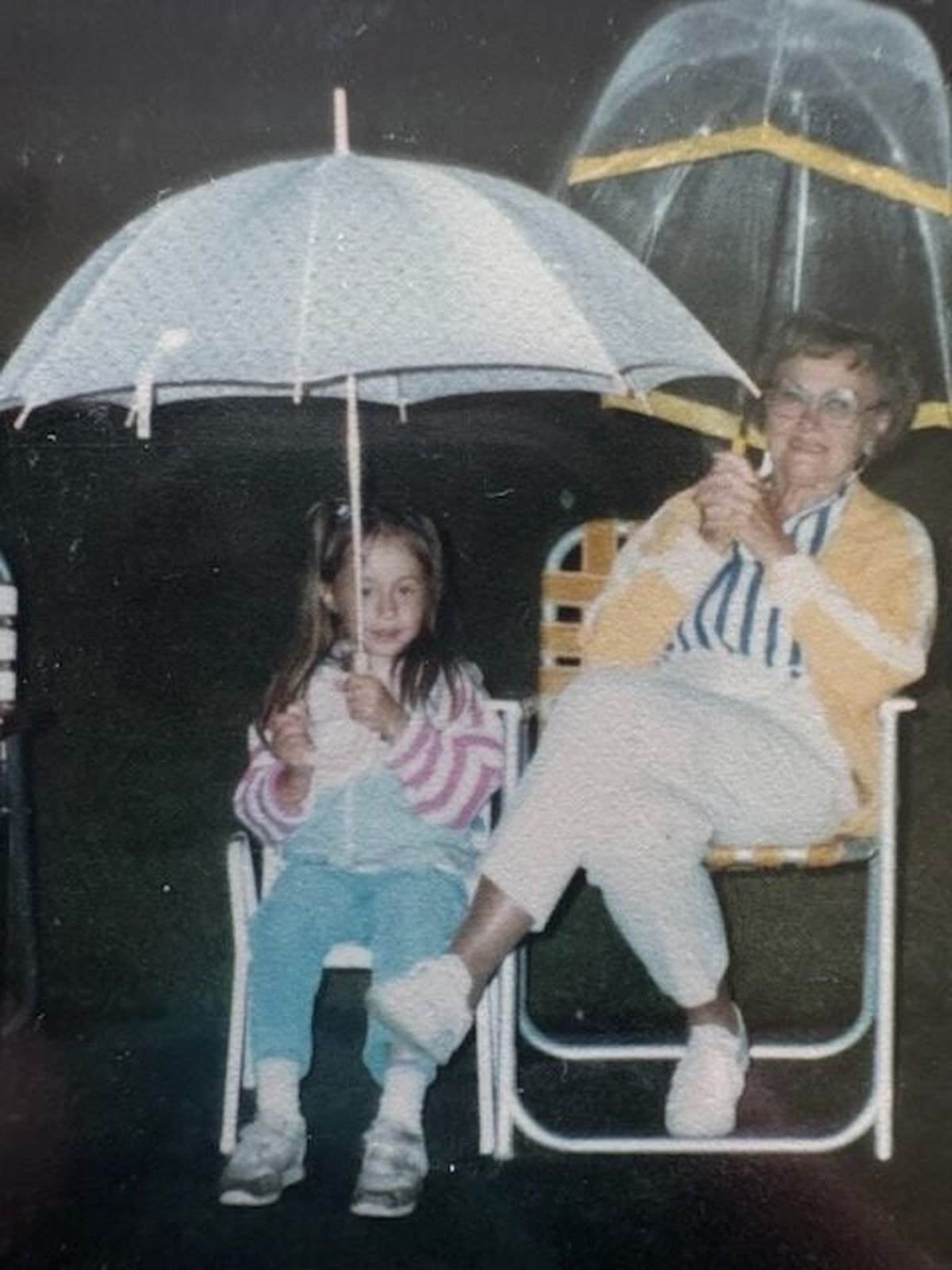 A young Shelby Van Pelt sits with her Grandma Anna under umbrellas in the rain. Anna was the inspiration behind the character Tova in Van Pelt’s debut novel, “Remarkably Bright Creatures.” (Courtesy of Shelby Van Pelt)