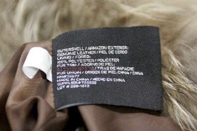 
A line on the label in this jacket, photographed in Farmers Branch, Texas, on Thursday, has been marked out where it purported that the fur trim on this jacket was from a raccoon. 
 (Associated Press / The Spokesman-Review)