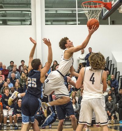 Bellarmine’s Malachi Flynn, driving to the basket against Olympia last season, averaged 29.7 points per game in his senior season. (Dean J. Koepfler / Tacoma News Tribune photo)