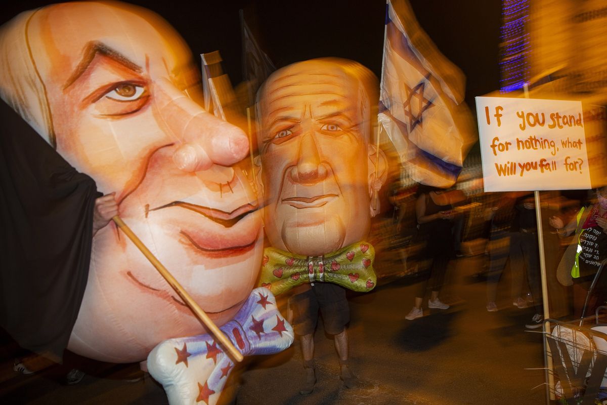 FILE - In this Saturday, Aug. 8, 2020 file photo, demonstrators wear mask depicting Israel