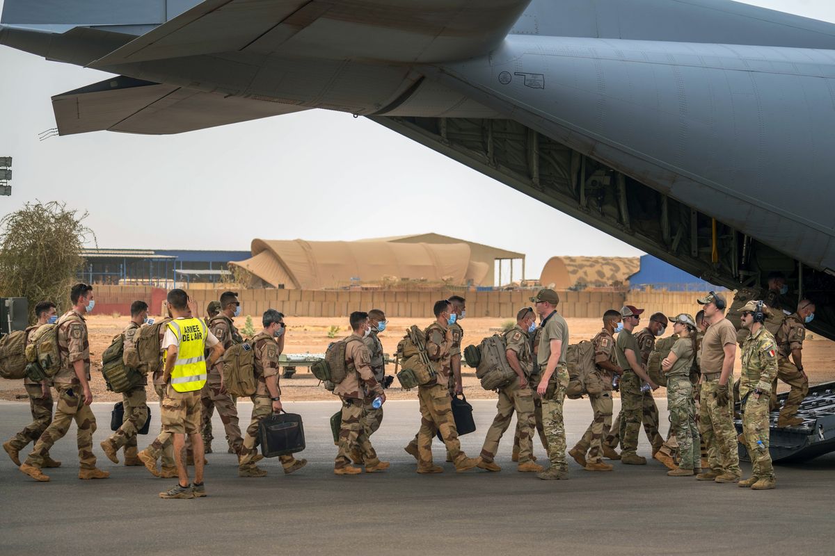 FILE - French Barkhane force soldiers who wrapped up a four-month tour of duty in the Sahel board a US Air Force C130 transport plane, leave their base in Gao, Mali Wednesday June 9, 2021. European leaders said troops from the European-led military task force known as Takuba will withdraw from Mali, while France is expected Thursday to announce the pullout of its own troops from the West African country.  (STF)