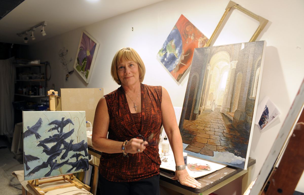 Janette “JKay” Borland stands in her basement studio with some of her work at her Spokane home  July 21. Her work is mostly acrylic paints with classical, nature and whimsical imagery.jesset@spokesman.com (Jesse Tinsley / The Spokesman-Review)