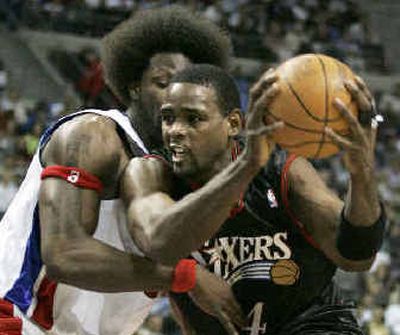 
Detroit Pistons center Ben Wallace, left, impedes the progress of Philadelphia 76ers forward Chris Webber during first-quarter action on Tuesday.
 (Associated Press / The Spokesman-Review)