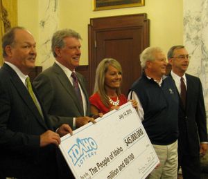 From left, Idaho Lottery Commission Chair Mel Fisher, Gov. Butch Otter, state schools Supt. Sherri Ybarra, Permanent Building Fund Council Chair Dee Jameson, and Lottery Director Jeff Anderson post with a blowup of a $45 million check in the governor's office on Tuesday, to mark the latest dividend from the state lottery. (Betsy Z. Russell)