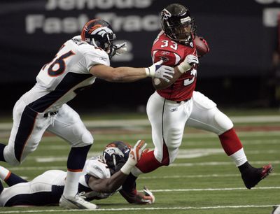 Denver’s Spencer Larsen (46), a rookie from Arizona, chases Atlanta tailback Michael Turner.  (Associated Press / The Spokesman-Review)