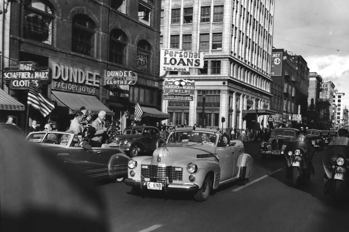1944: Republican presidential hopeful New York Gov. Thomas E. Dewey, seen through the windshield of a 1941 Cadillac convertible, rides with wife Frances down Riverside Avenue during a Sept. 16 campaign visit to Spokane. He arrived at the Northern Pacific station and was en route to the Davenport Hotel, followed by more than 75 press representatives on his opening campaign tour. Dewey would go on to lose to Franklin D. Roosevelt, then try again unsuccessfully in 1948 against Harry S. Truman, who visited Spokane in June 1948.  (The Spokesman-Review photo archive)