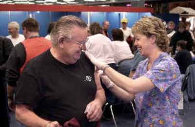 
Panhandle Health District nurse Donna Marshall-Holden prepares Gary George, of Hayden Lake, for a flu shot Friday at Silver Lake Mall in Coeur d'Alene. 
 (Tom Davenport/ / The Spokesman-Review)