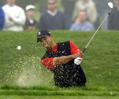
Tiger Woods blast from the bunker on the 11th hole where he made a bogey in the final round of the Buick Invitational. 
 (Associated Press / The Spokesman-Review)