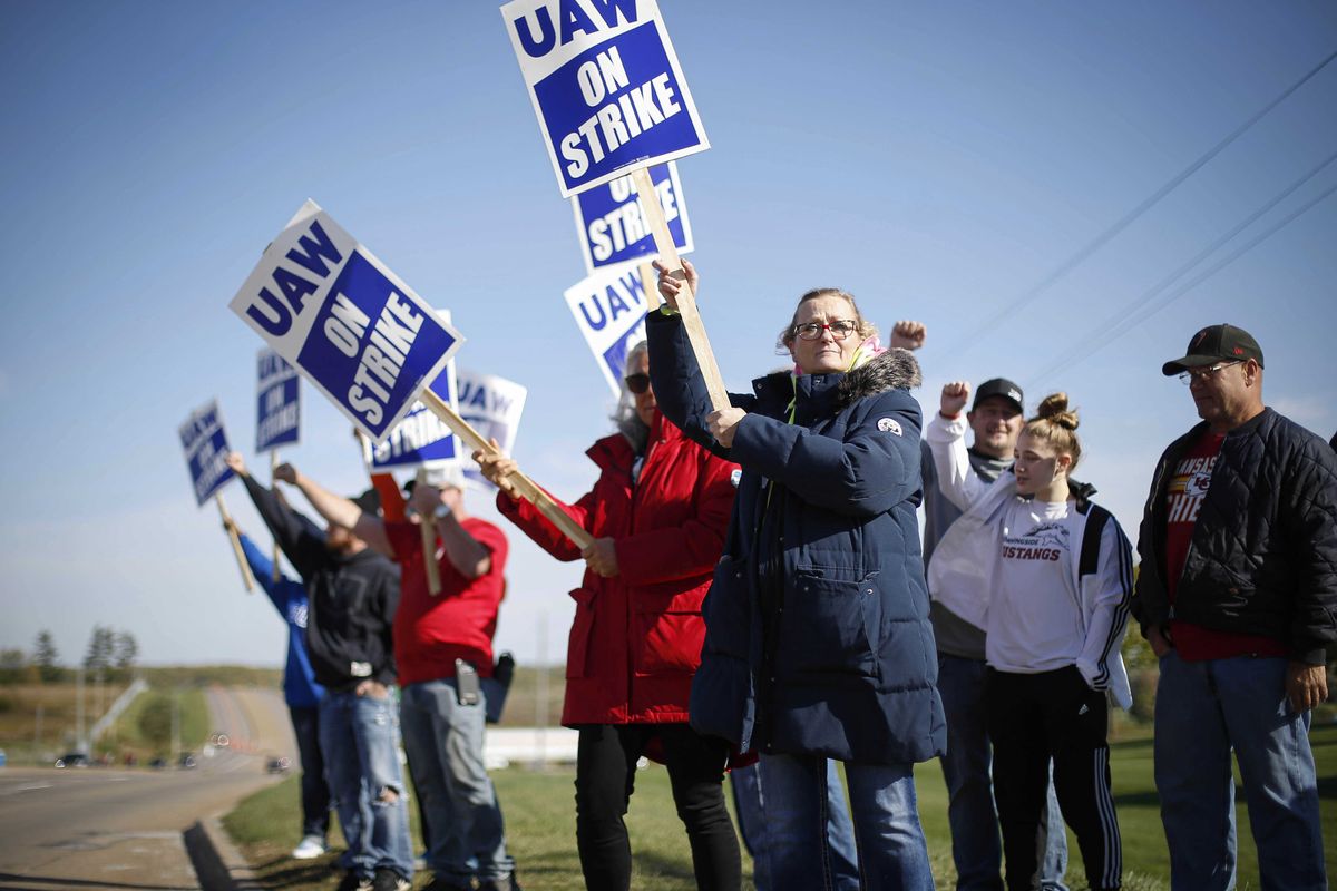 Members of the United Auto Workers strike outside of the John Deere Engine Works plant on Ridgeway Avenue in Waterloo, Iowa, on Friday, Oct. 15, 2021. About 10,000 UAW workers have gone on strike against John Deere since Thursday at plants in Iowa, Illinois and Kansas.  (Bryon Houlgrave)