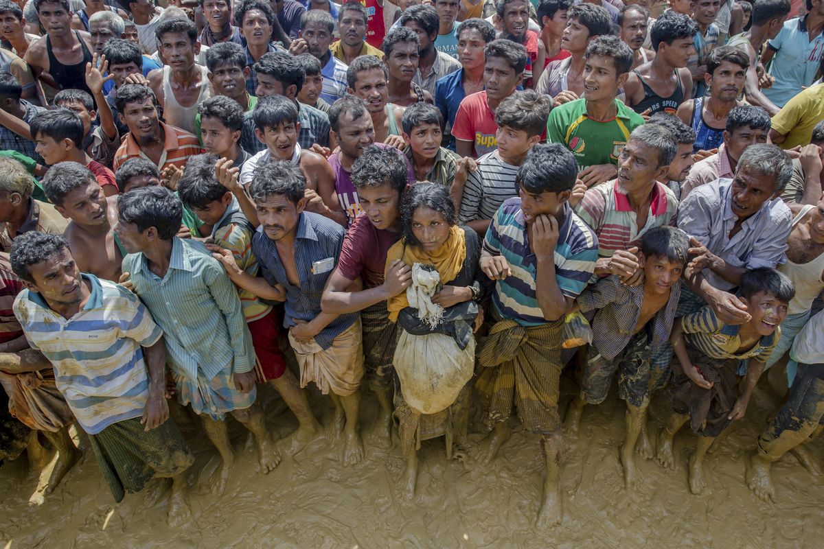 Rohingya Muslims, who crossed over from Myanmar into Bangladesh, wait to receive handouts near Balukhali refugee camp, Bangladesh, Thursday, Sept. 21, 2017. (Dar Yasin / Associated Press)