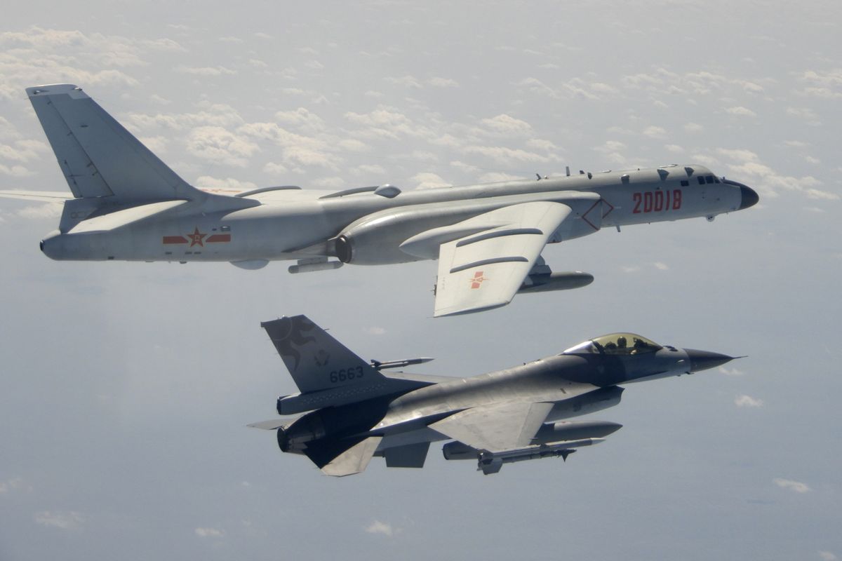 In this photo taken Feb. 10, 2020, and released by the Republic of China (ROC) Ministry of National Defense, a Taiwanese Air Force F-16 in foreground flies on the flank of a Chinese People