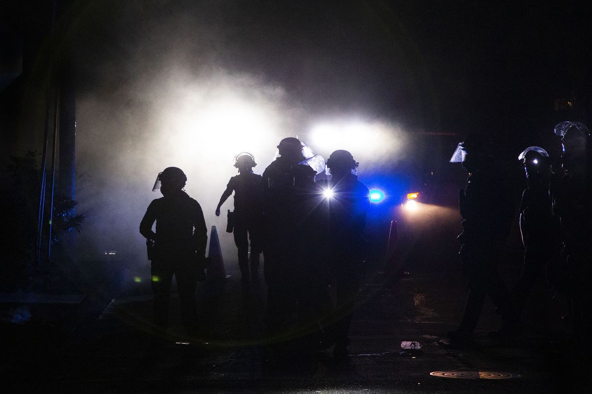 A march on the Portland police union headquarters drew a rapid police response after someone set a fire next to the building on Monday, Aug. 24, 2020. (Associated Press)