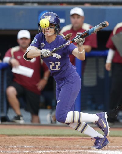 Washington infielder Sis Bates (22) hits a sacrifice bunt in the fifth inning of the first softball game against Florida State in the best-of-three championship series in the NCAA Women's College World Series in Oklahoma City, Monday, June 4, 2018.   (Associated Press)