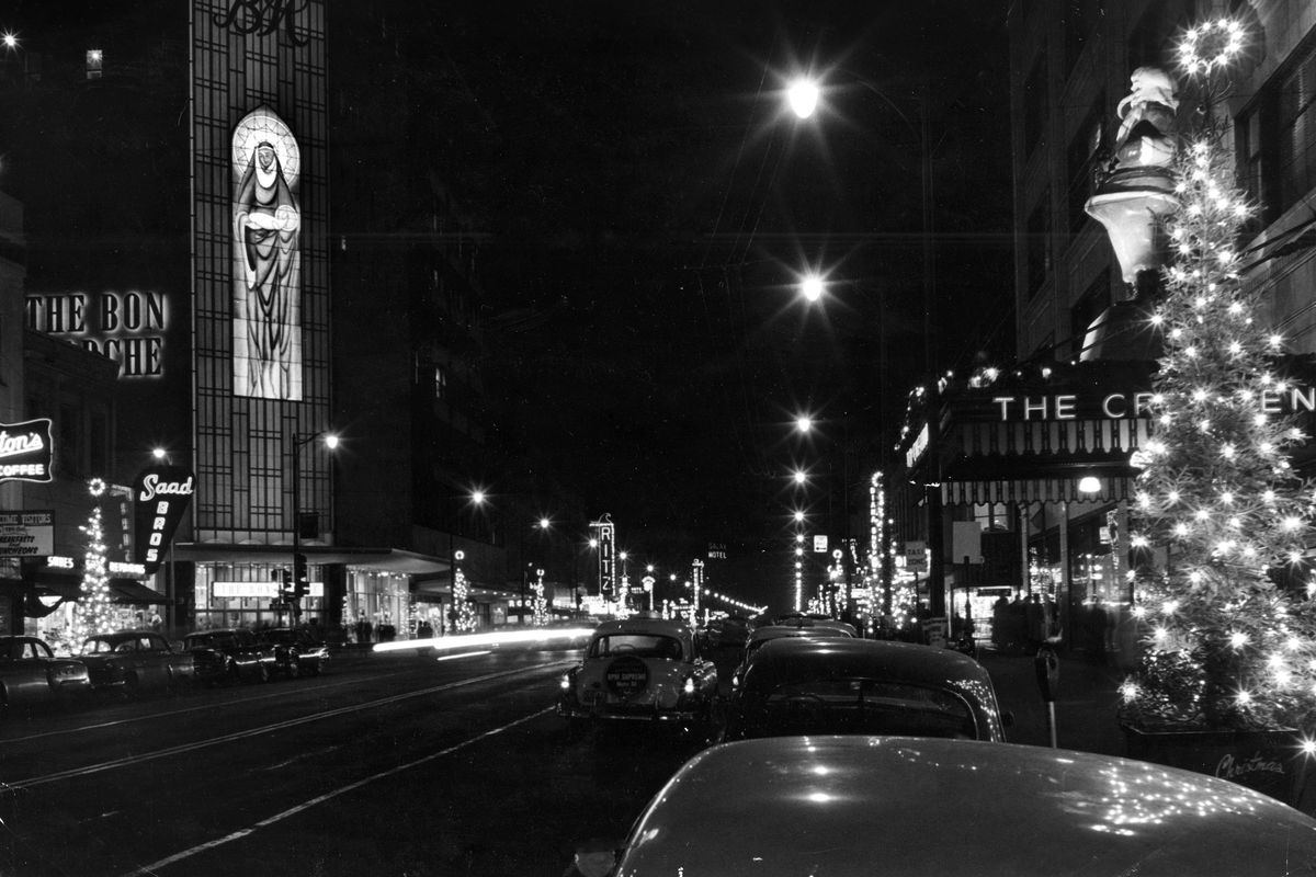 1957: This night photo from The Spokesman-Review shows the Madonna and child faux stained-glass lighted decoration on the new Bon Marche department store in downtown Spokane. Across Main Avenue from the Bon was the Crescent department store, a hometown favorite famous for its holiday décor and windows, which featured a 13-foot fiberglass Santa Claus above the store’s marquee seen at right. The giant Santa was displayed until the store closed for good in 1992. Later it was bought by White Elephant co-owner Pat Conley and displayed seasonally at the popular sporting goods stores.  (Spokesman-Review photo archives)