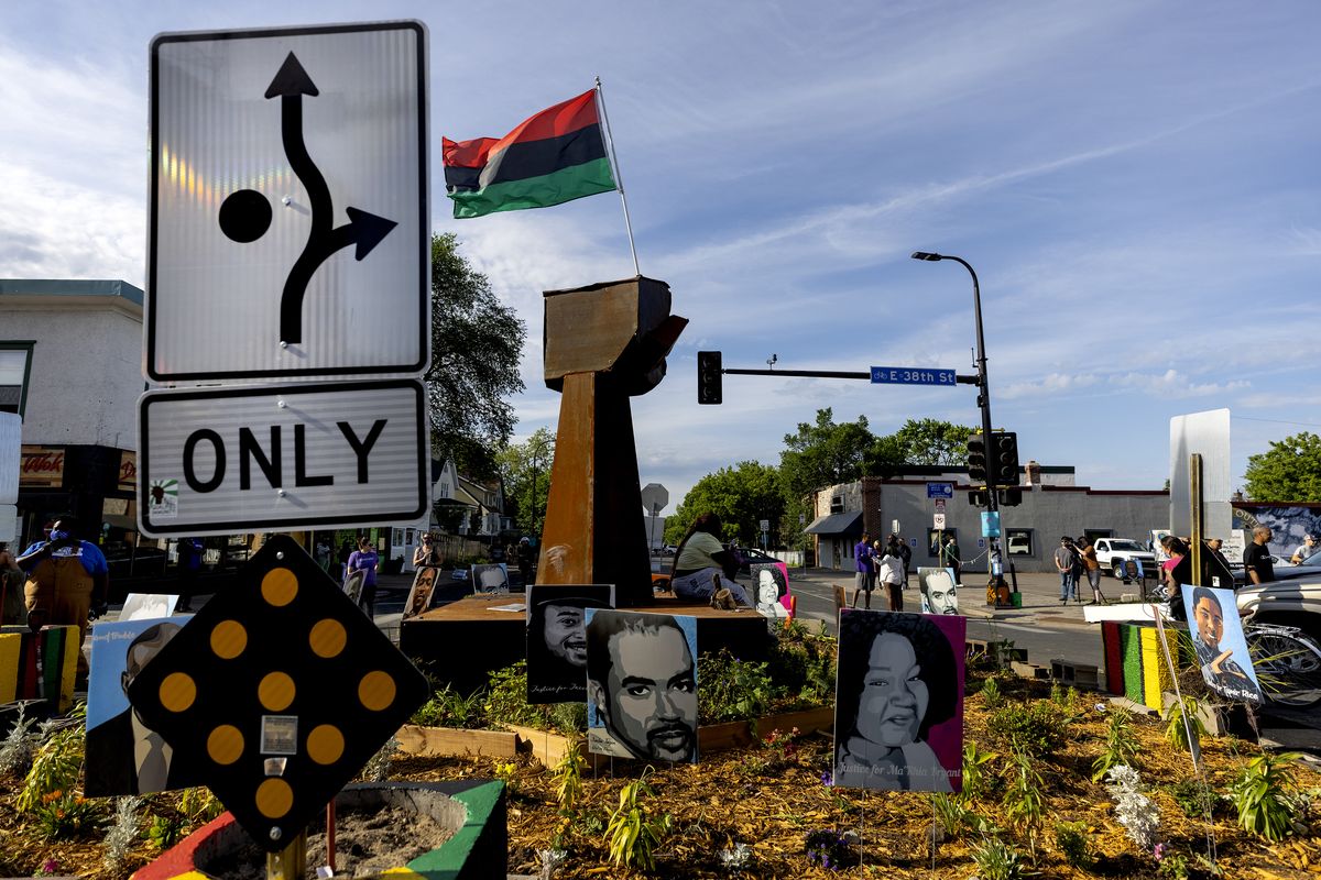 A traffic sign signals directions around the monument at George Floyd Square, Thursday, June 3, 2021, in Minneapolis. Crews are removing concrete barriers as well as artwork, flowers and other memorial items from a Minneapolis intersection that has become a sprawling memorial to George Floyd. (Carlos Gonzalez)