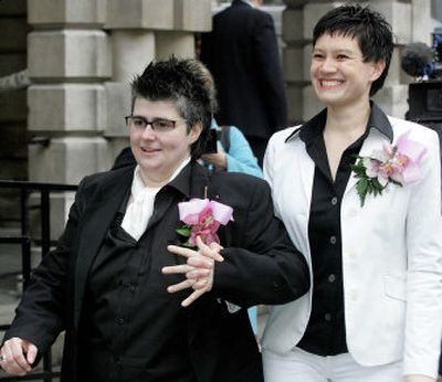 
Shannon Sickles, right, and Grainne Close leave Belfast City Hall, Northern Ireland, Monday. The couple are the United Kingdom's first same-sex couple to win legal recognition under a new British civil partnership law. 
 (Associated Press / The Spokesman-Review)
