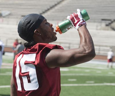 Wide receiver Robert Lewis takes a drink between drills during practice on Aug. 3. (Jesse Tinsley / The Spokesman-Review)