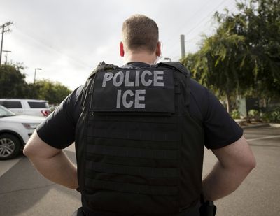 A U.S. Immigration and Customs Enforcement officer looks on during an operation in Escondido, California, on Monday, July 8, 2019. International students will be forced to leave the United States or transfer to another college if their schools offer classes entirely online this fall, under new guidelines that ICE issued Monday.  (Gregory Bull / The Associated Press)