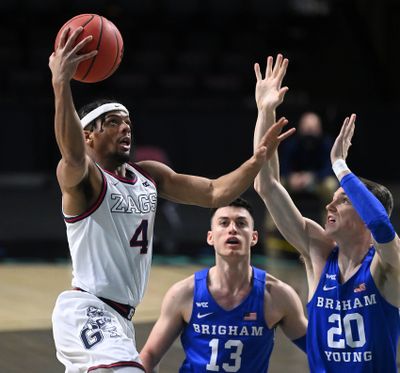 Gonzaga guard Aaron Cook, left, eyes the basket against BYU in the WCC Tournament title game in Las Vegas.  (Colin Mulvany/The Spokesman-Review)