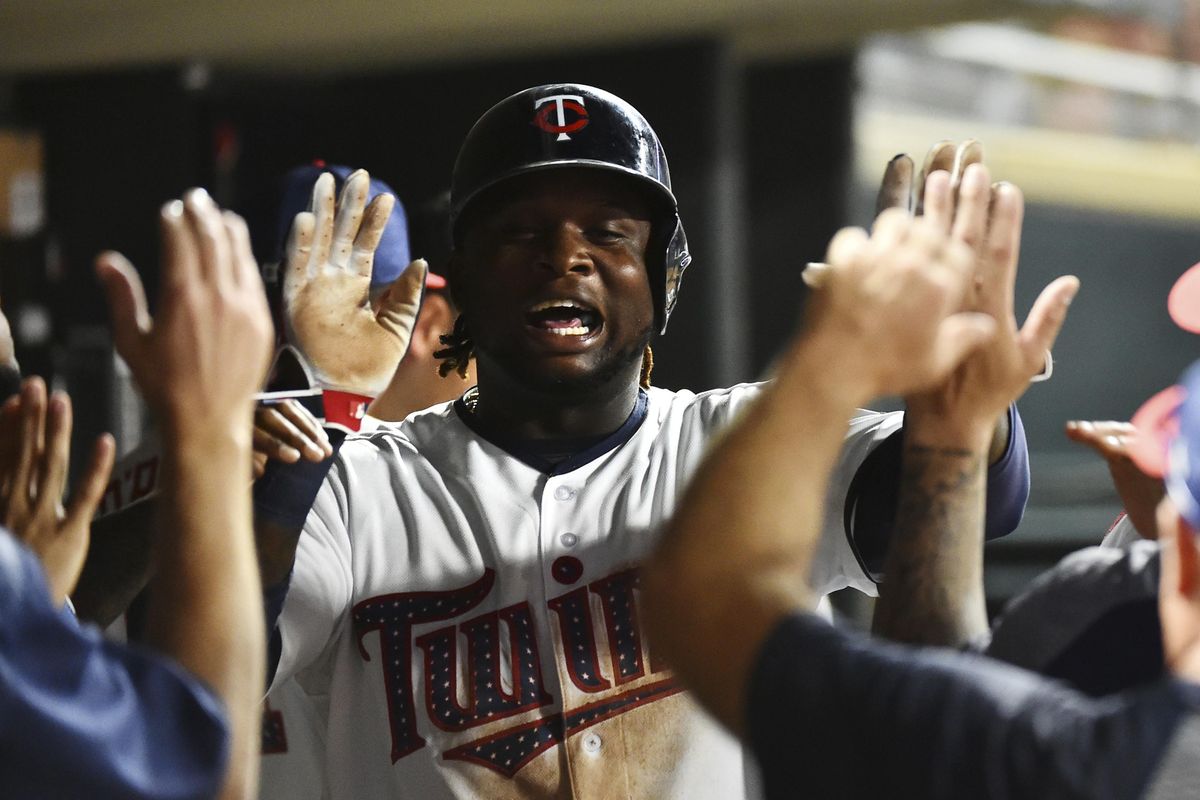 Minnesota Twins third baseman Miguel Sano is congratulated by teammates in the dugout after scoring a run during a 2017 game. Sano will not face criminal charges from a traffic incident in his native Dominican Republic. (John Autey / Associated Press)