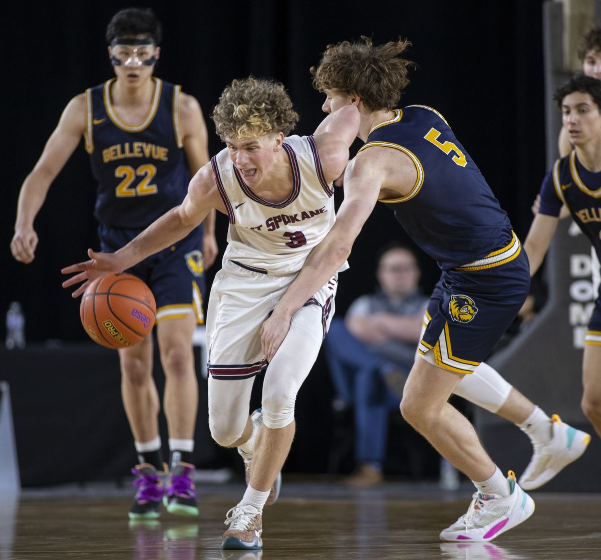 Mt. Spokane’s Ryan Lafferty draws a foul from Bellevue’s Andrew Gooding on Thursday in the State 3A basketball tournament in Tacoma.  (Patrick Hagerty)