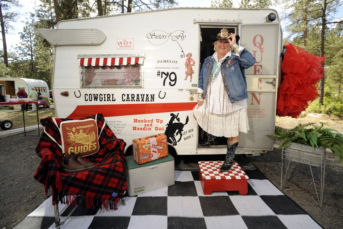 Pam Heron, also known as the “Queen of Pamelot,” stands in the doorway of her 1965 Shasta compact travel trailer on  Saturday in Riverside State Park. She’s a member of Sisters on the Fly,   women who share  a love of  “glamping”  in vintage trailers. (Colin Mulvany)